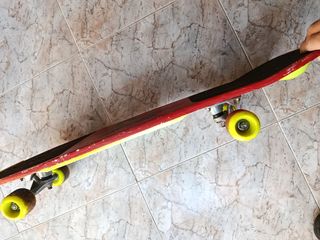 Monopatín rojo con diseño de patinador