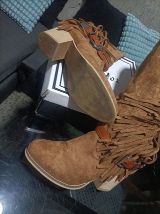 Botas altas de flecos ante marrón