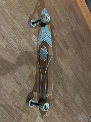 Longboard con diseño de madera y detalles plateado