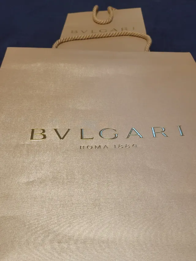 Conjunto Bolsas Bvlgari Doradas y Beige.