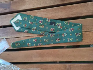 Corbata verde con escudos dorados.