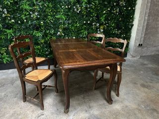 Mesa de comedor antigua de madera con sillas.