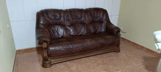 Sofá de piel marrón con detalles de madera