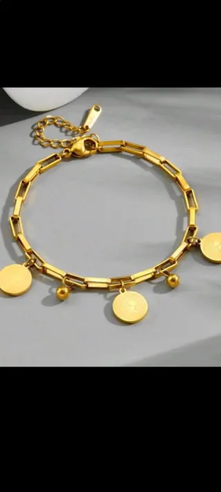 Pulsera dorada con dijes de oro 18 k liminado