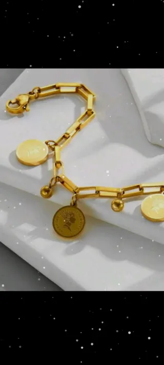 Pulsera dorada con dijes de oro 18 k liminado