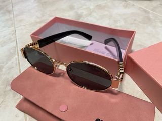 Gafas de sol Miu Miu doradas y negras