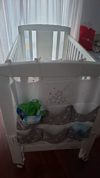 Cuna de madera blanca con ruedas