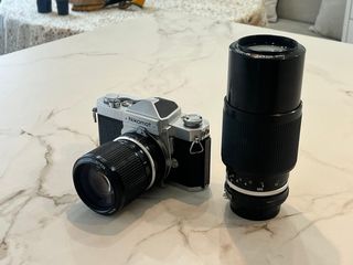 Nikomat FT con 2 objetivos zoom.