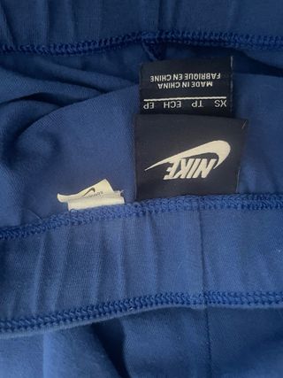 Mallas Nike azules con logo naranja fosforito