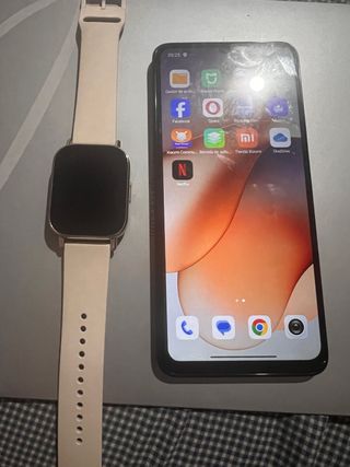 Reloj y móvil con cajas y cargadores