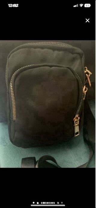 Bandolera negra con cremalleras doradas