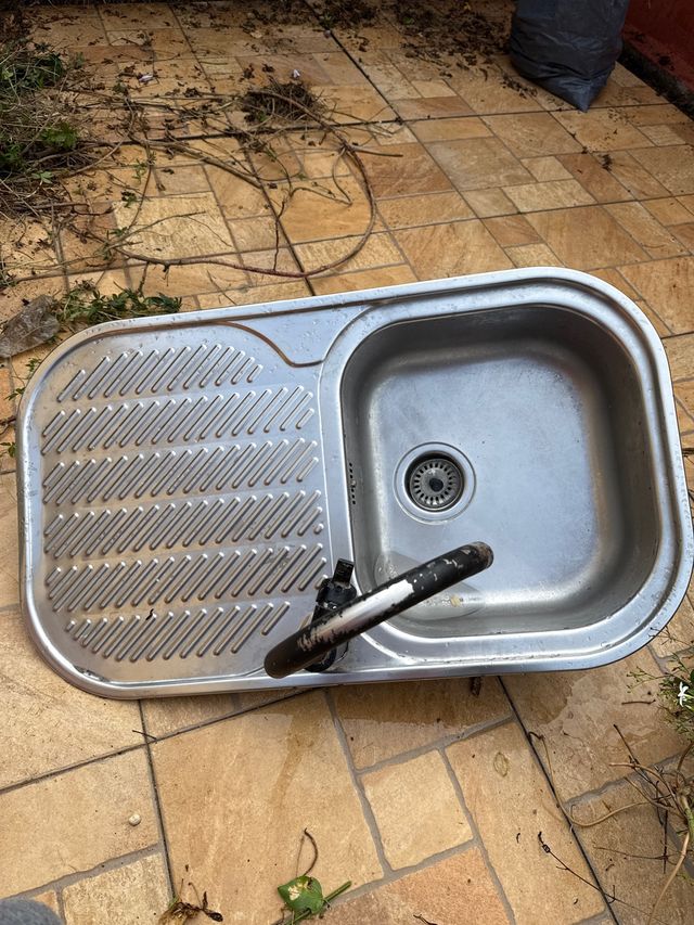 Fregadero de cocina metálico con escurridor