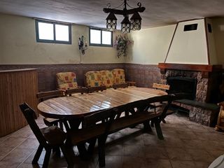 Mesa de madera rústica con bancos y sillas.