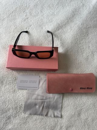 Occhiali Miu Miu neri con lenti arancioni