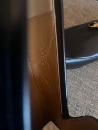 Mocassini Gucci neri con morsetto dorato satinato