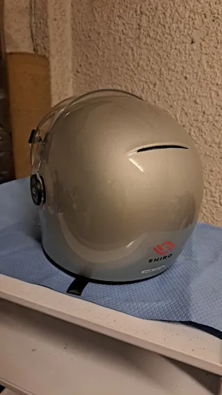 Casco de moto plateado con visera