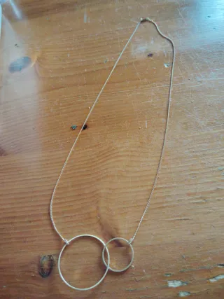 Collar dorado con dos aros entrelazados