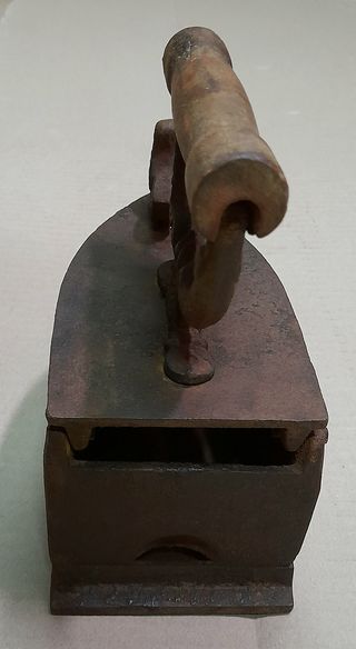 Plancha antigua de hierro con adorno de pájaro