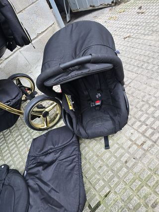 Carro de bebé negro y dorado adamex