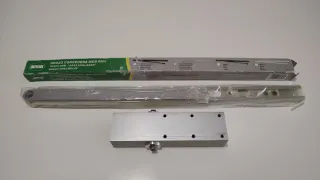 Muelle para puerta con brazo corredero