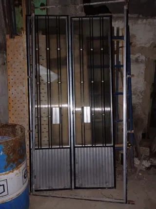 Puerta exterior con rejas y cristal