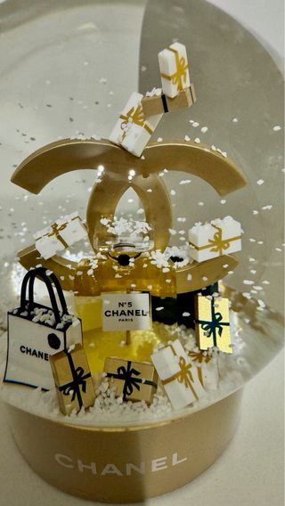 Bola de nieve Chanel dorada con regalos
