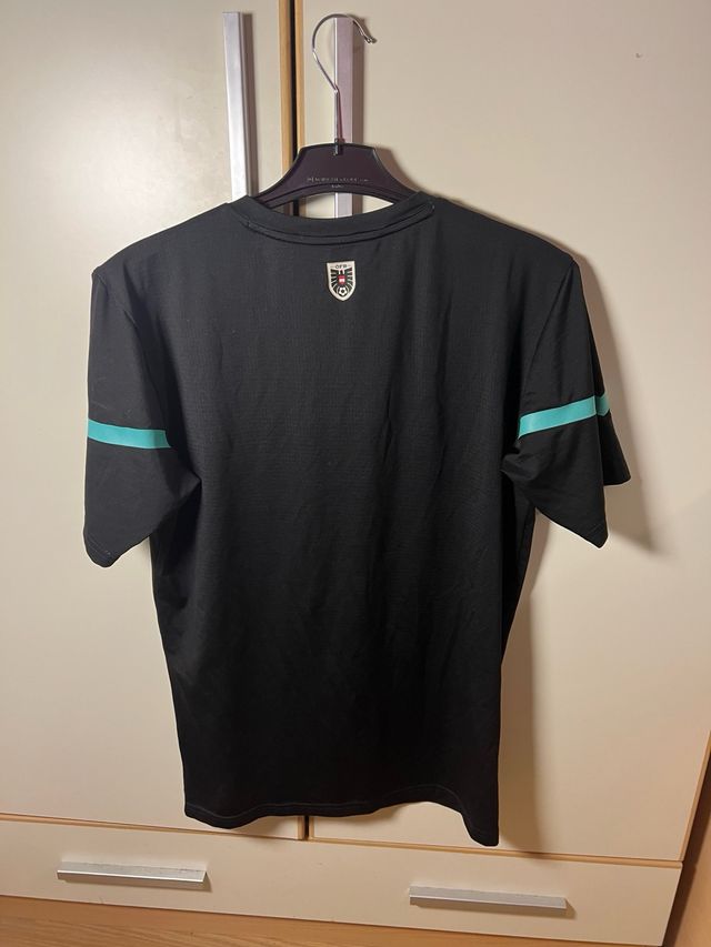 Camiseta Puma Austria Negra y Turquesa