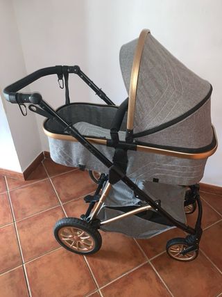 Carrito de bebé gris y dorado