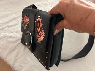 Bolso negro con flores bordadas.