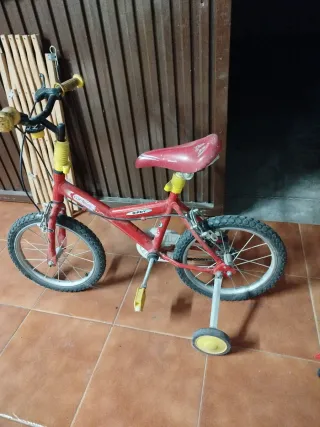 Bicicleta infantil roja con ruedines