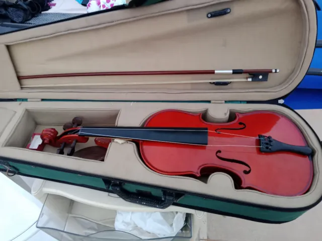 Violín rojo con arco y estuche