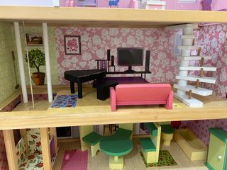 Casa de muñecas de madera con accesorios.