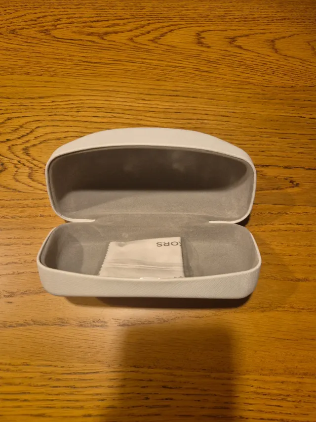 Funda de gafas Michael Kors blanca.