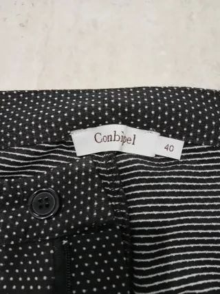 Pantaloni neri a pois bianchi