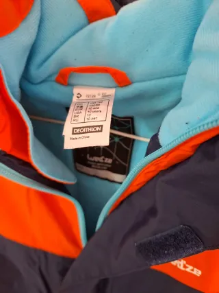 Mono de nieve infantil naranja y azul