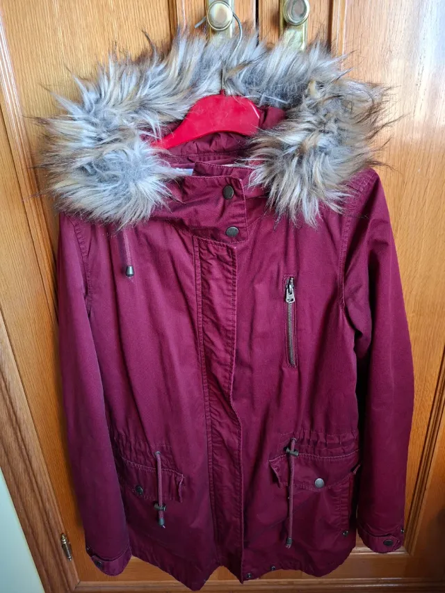 Trenca color burdeos, con capulla con pelo