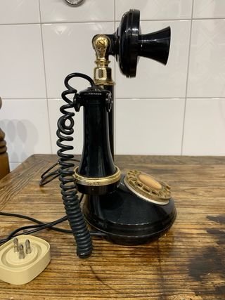 Telefono antico nero e oro, funzionante