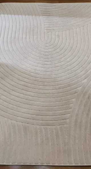 Alfombra beige con diseño de círculos