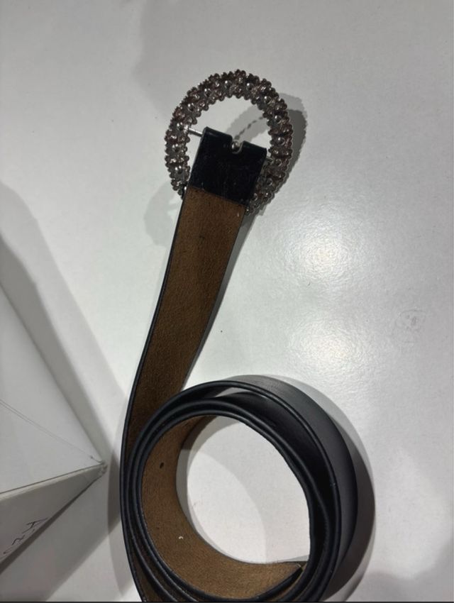 Cinturón negro con hebilla plateada y pedrería