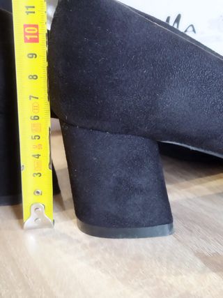Zapatos de tacón negros ante mujer