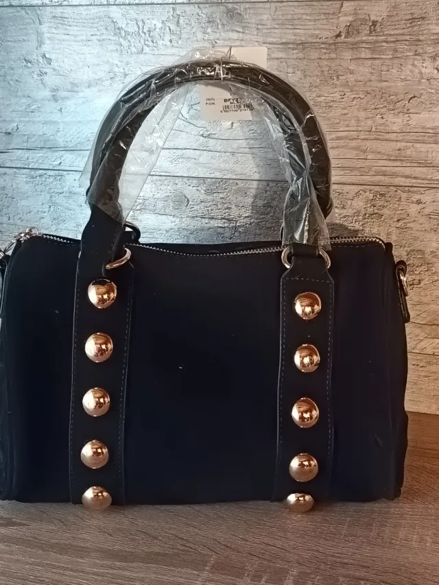Bolso negro con tachuelas doradas