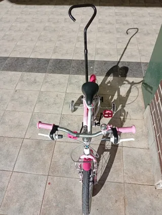 Bicicleta infantil rosa con ruedines