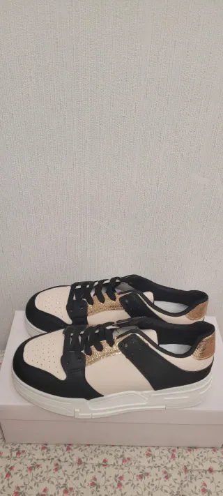 Zapatillas deportivas negras, doradas y blancas