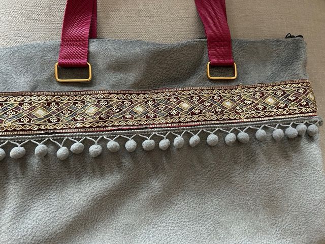 Bolso de tela gris con detalles rojos