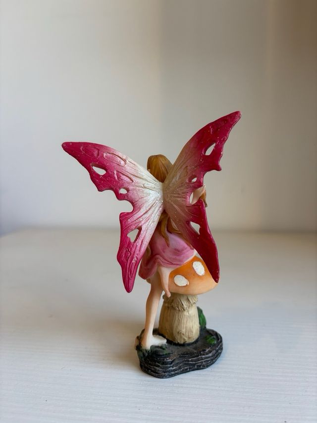 Fatina seduta su fungo