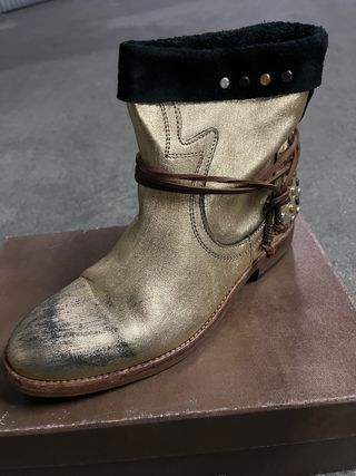Botas doradas con tachuelas