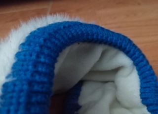 Gorra visera de lana forrada azul con pelo blanco.