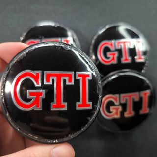 TAPABUJES VW GTI 65mm NEGROS - EMBLEMA VOLKSWAGEN