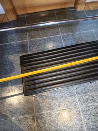 Camilla con taburete y portarrollos de papel.