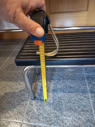 Camilla con taburete y portarrollos de papel.